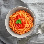 Cavatelli pasta in tomato sauce closeup top view