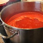 A pot of tomato sauce reducing on the stove