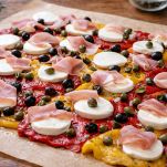 Mozzarella, peperoni, prosciutto, capperi e olive