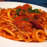 Spaghetti con piselli e calamari