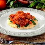 Nasello e polenta al sugo rosso