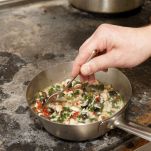 18877349 – chef is stirring risotto, copy space