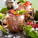 Moscow mule cocktail with lime and strawberry