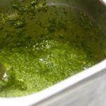 Recipe for pesto sauce. Basil leaves with olive oil are whipped