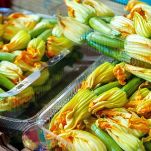 zucchini flowers and ovaries in a box for sale. Harvest delicious zucchini ovaries for cooking in batter