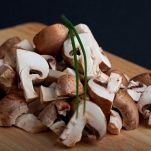 heap of chopped mushrooms on a wooden board