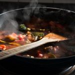 Ratatouille cooking in a frying pan on a hob