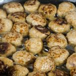 Frying homemade meatballs in a frying pan