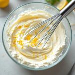 Crema di formaggio con scorza di limone in ciotola.