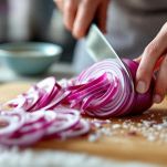 Cipolla rossa affettata immersa in ciotola con acqua e sale.