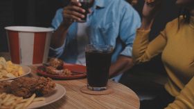 donna mangia e beve in un fast food