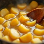 Pentola con marmellata mescolata con cucchiaio