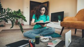 Ragazza concentrata che studia mentre mangia