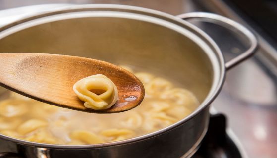 Tortellino in primo piano con pentola di cottura sullo sfondo