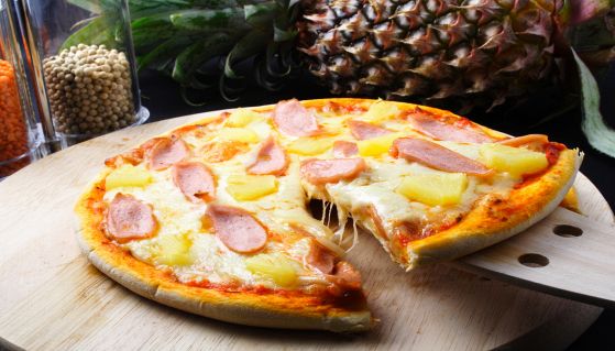 Pizza con l'ananas con formaggio filante