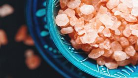 Cristalli rosa di sale dell'Himalaya in una ciotola blu