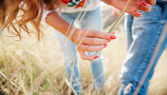 Ragazza coglie erbe spontanee in un campo