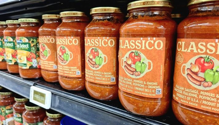 Scaffale con barattoli di sughi pronti per la pasta