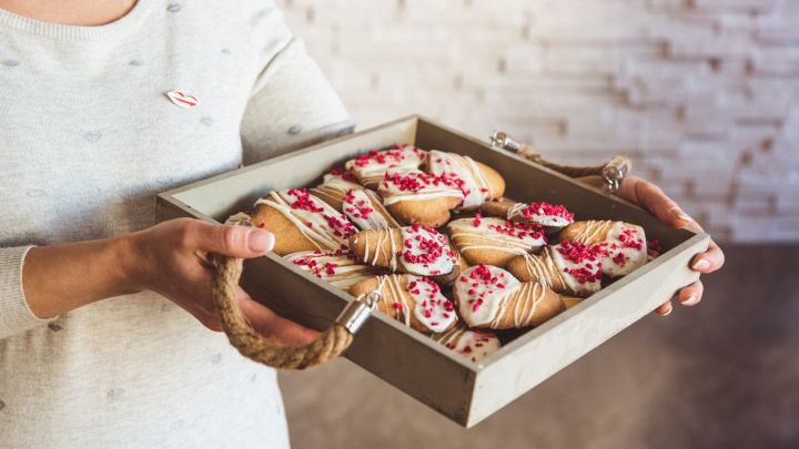 Biscotti fatti in casa a forma di cuore all'interno di un vassoio di legno
