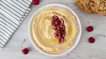 Piatto con hummus con ciliegie arrostite