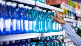 Mani femminili acquistano bottiglia d'acqua
