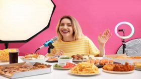 Influencer con tanti cibi sul tavolo