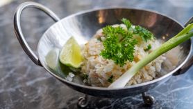 Vassoio d'acciaio con riso al cocco con prezzemolo e lime