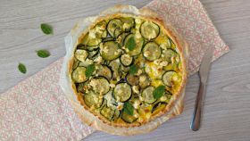 Piatto con quiche con zucchine, feta e menta fresca