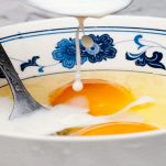 Uova, latte e panna nella ciotola