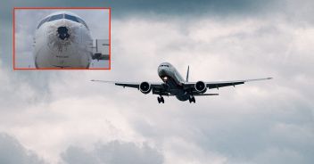 Passenger plane comes in for landing in cloudy weather.