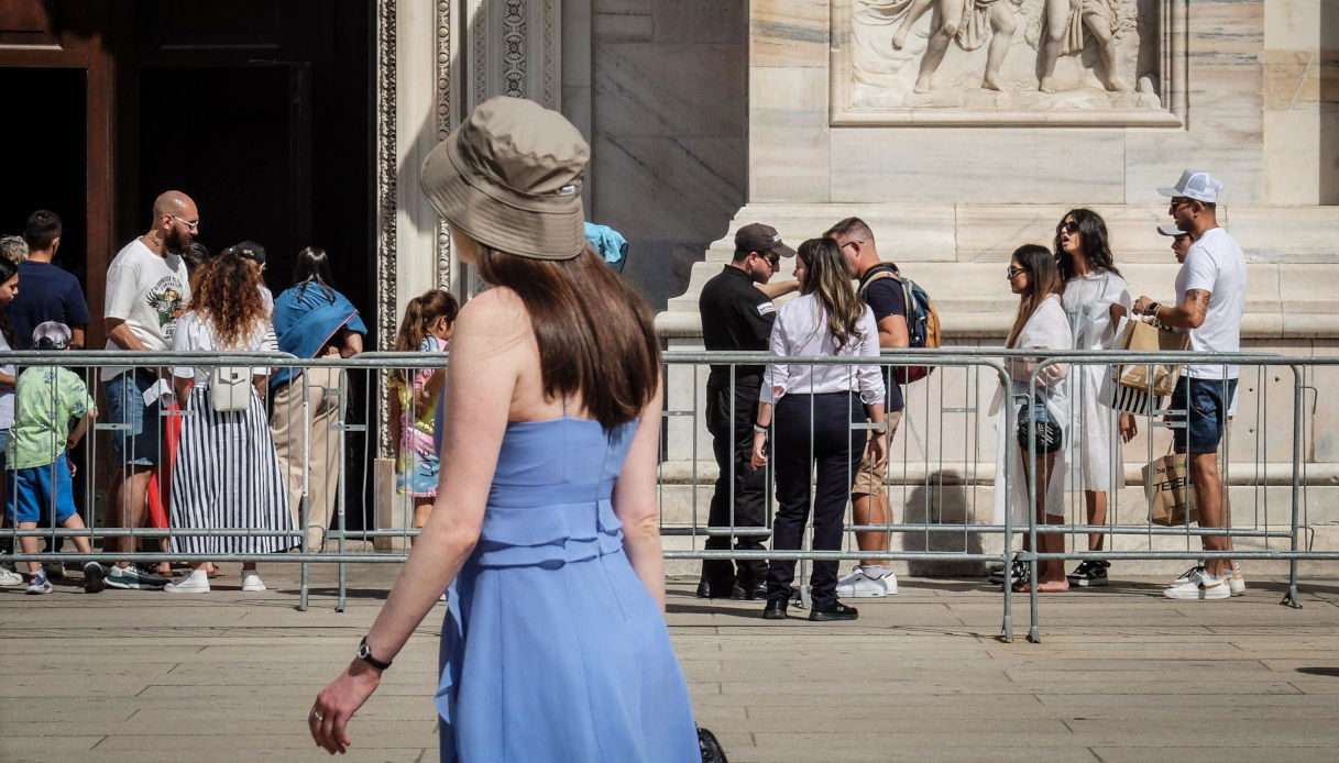 Una ragazza cammina davanti al Duomo di Milano