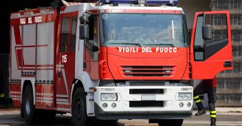 italian fire trucks with sirens blue and a fireman ready for emergency