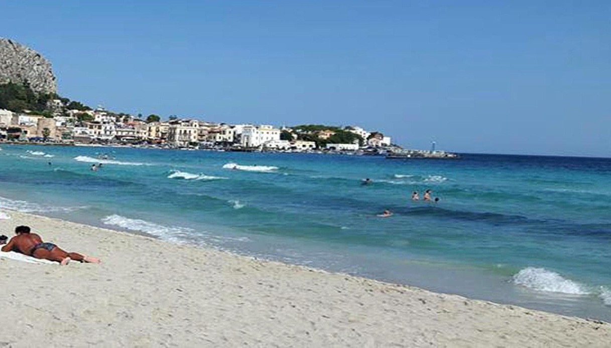 ispettore in relax in spiaggia a palermo vede una donna annegare e si butta in mare salvataggio eroico