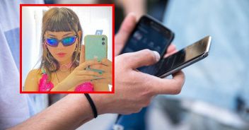 man hand smart phone in street