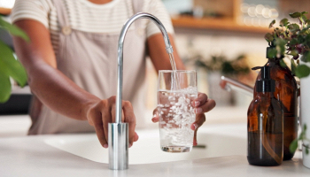 donna che riempie l'acqua dal rubinetto