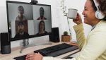 Persona in smart working che partecipa a una video call con webcam su monitor