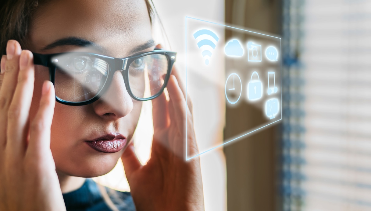 https://wips.plug.it/cips/tecnologia/cms/2026/03/donna-con-smart-glasses.jpg