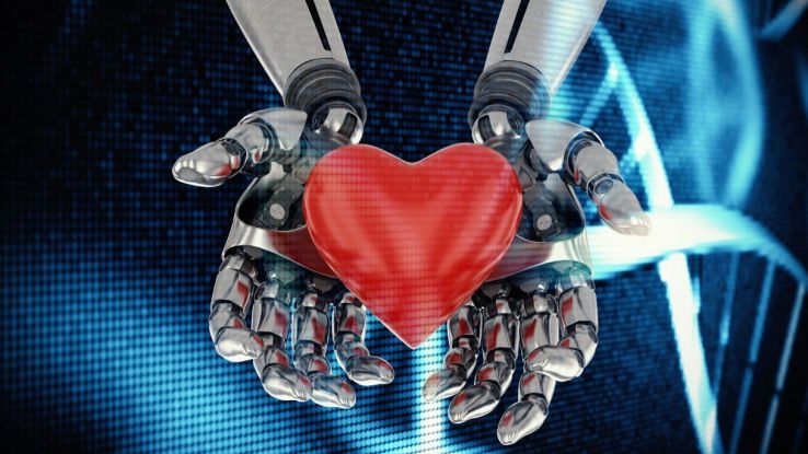 Cuore rosso in mani robotiche