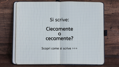 Scritta centrata “Si scrive ciecamente o cecamente? Scopri come si scrive...” su quaderno a quadretti appoggiato su un tavolo di legno