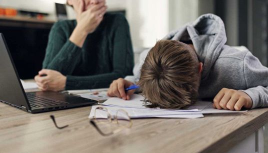 Genitori aiutano i figli con i compiti a casa